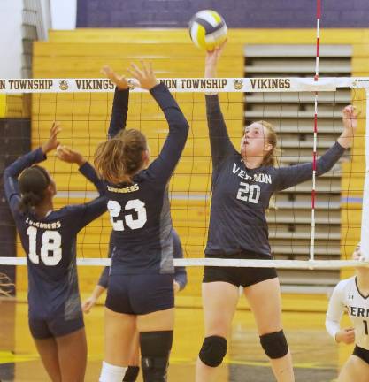 Vernon's Kaitlyn Buurman hits the ball above the net. Buurman accomplished 6 kills, 16 digs and 2 aces.