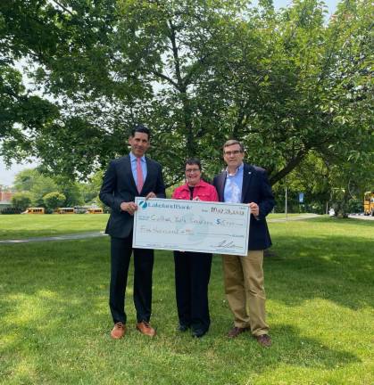 Tom Stackhouse, executive vice president, chief credit cfficer of Lakeland Bank, and Dan Gonzalez, the bank’s senior vice president, present Sister Debbie Drago, executive director of Collier Youth Service, with a check for $5,000. Provided photo.