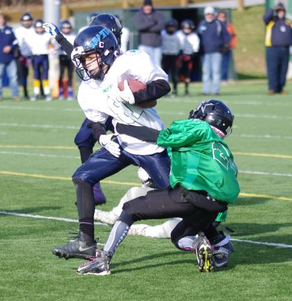 White ball carrier Eli Rippey is grabbed by Green defender Shane Nugent. The North Jersey Youth Football League (NJYFL) Super Pee Wee (5th &amp; 6th grade) All-Star game took place at Maple Grange Park in Vernon Township, New Jersey on Saturday, December 3rd 2016. The Green all-stars beat the White all-stars 8-0. The Green all-stars consisted of players from Wallkill Valley, West Milford, High Point and Kittatinny. The White all-stars consisted of players from Sparta, Ringwood, and Vernon. The NJYFL teams are based in the counties of Passaic and Sussex in the state of New Jersey.