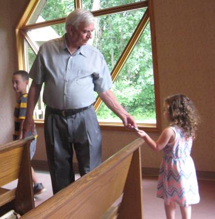 PHOTOS BY JANET REDYKE Children distribute special Father&#xfe;&#xc4;&#xf4;s Day gifts to fathers, grandfathers, godfathers and step-fathers after the Sunday Mass.