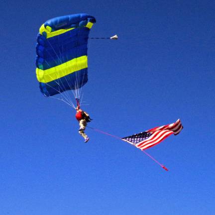 PHOTOS BY CHRIS WYMAN Wantage resident Rich Winstock, who is the owner of Sky Dive Sussex, started the Car, Truck and Bike Show with a dramatic entrance with a large American flag hanging from his waist. He was the last of ten skydivers to arrive at Woodbourne Veterans Memorial Park on Oct. 11.