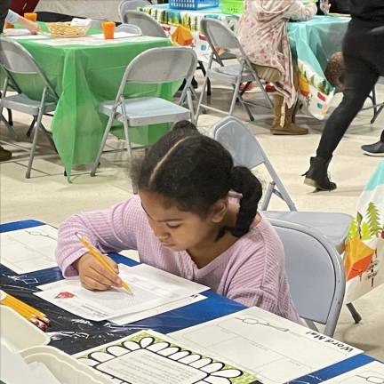 A student works on various activities during Reading Night at Wantage School.