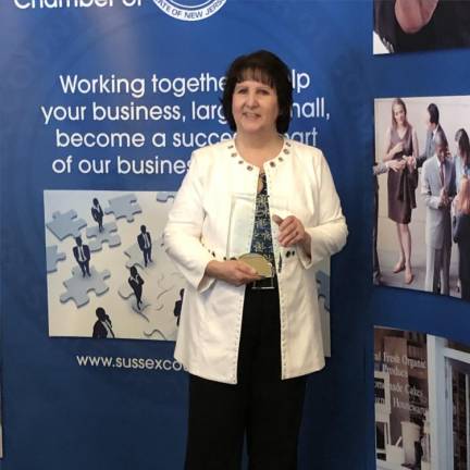 Becky Carlson, executive director of the Center for Prevention &amp; Counseling in Newton, holds the Businessperson of the Year Award. (Photo by Kathy Shwiff)