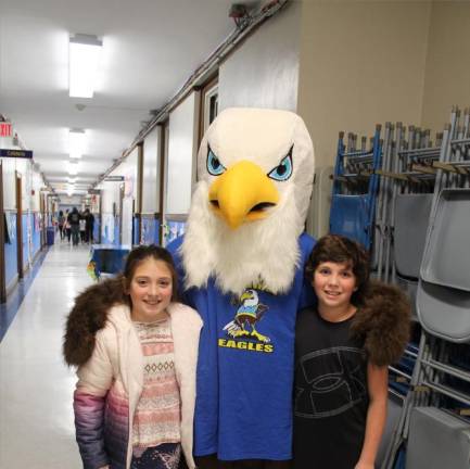 The Wantage Eagle poses with students during Reading Night at Wantage School.