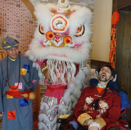 Photos by Vera Olinski Ricky Mun and one of his dancing liosn celebrate with Louis Smaglia at Wing's Asian Bistro.