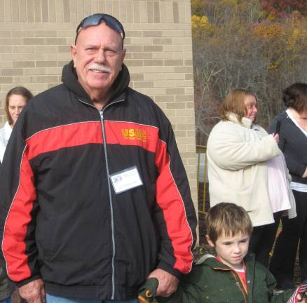 Marine veteran Ed and grandson Eddie Dombroski enjoy the procession.