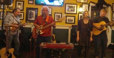 From left, Bob Marks, Ray Sikora, Beatty McArdle, and Brian McArdle sing and play at the Irish Cottage Inn.