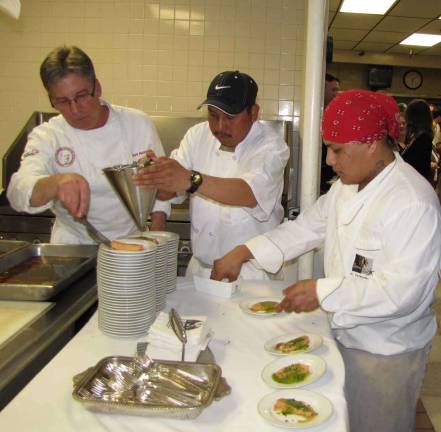 Perona Farms Executive Chef Kirk Avondoglio prepares a dish forA Taste of Talent.