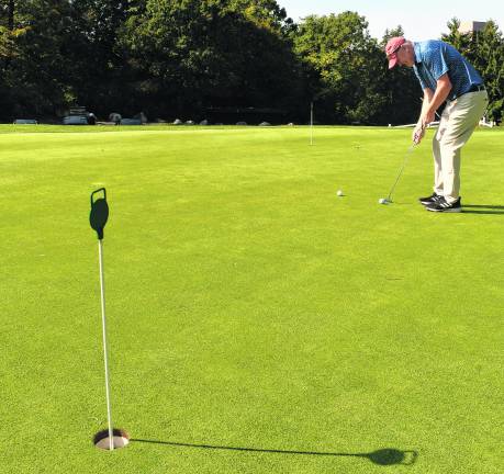 <b>Bob Carlucci of Sparta putts.</b>
