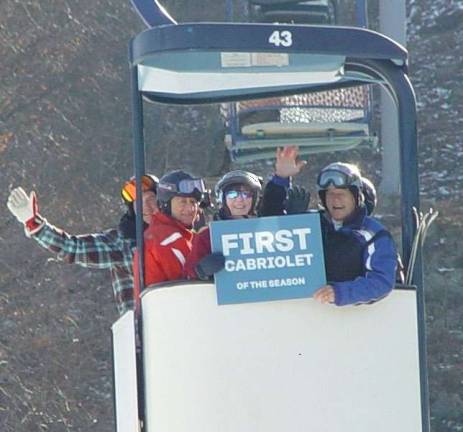 Buffy &amp; John Whiting, right and center ride the first cab with friends on opening day of the resort.