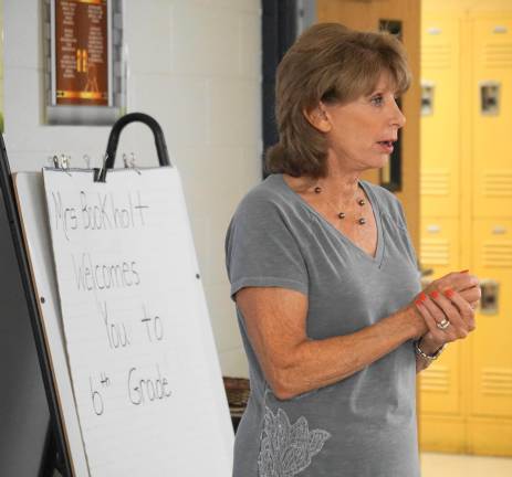 Teacher Jane Bookholt reviews classroom rules