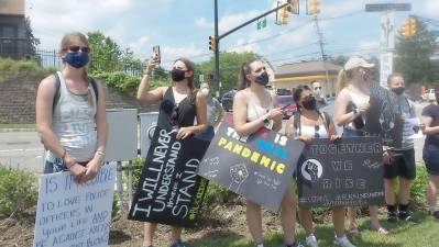 Many lined the sidewalk in front of CVS. Many also stood in the grassy area and held signs. People kept coming and many said 200+ came to protest against racism.