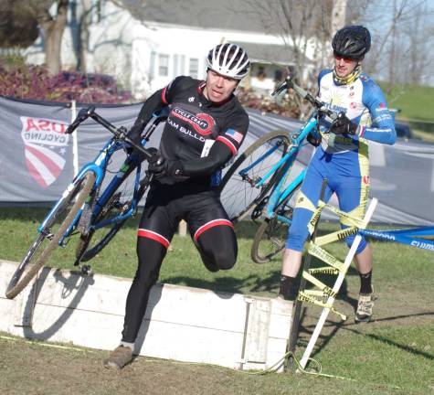 Cyclists Steve Mancuso of Team Bulldog followed by Andrew Logiudice of Skylands Cycling Club move along a section of the race course.