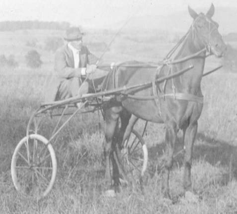 Peter Lott on his sulky with a farm horse that he drove in the afternoon trotter races in Deckertown in the late 1800s.