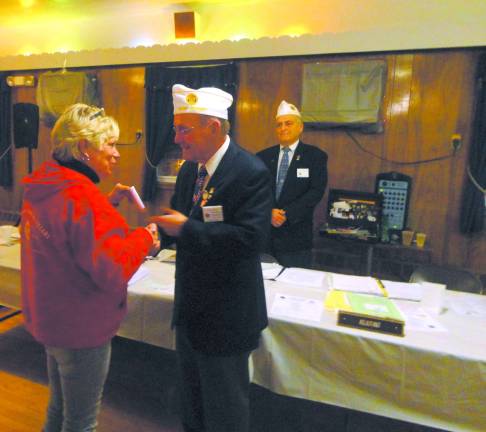 Photo by Scott Baker The American Legion Ladies' Auxiliary presents a $1,500 check to furnish a entire room at Veteran's Haven North.