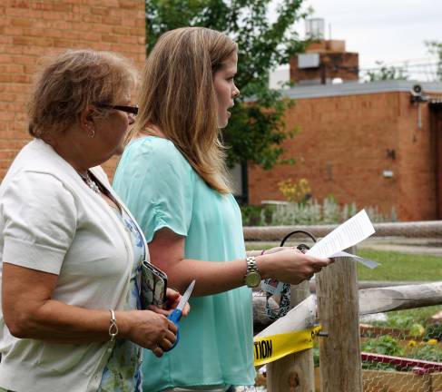 From right, Kristie Lyons speaks at the dedication as Shari Kenerson listens.