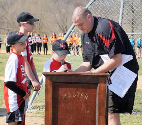 A Little League player reads the Little League Pledge with Sussex/Wantage Little League President Darryl Wurl on right.
