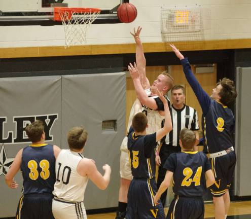 Wallkill Valley's Zane Crumb releases the ball towards the hoop during a shot attempt in heavy traffic in the first period.