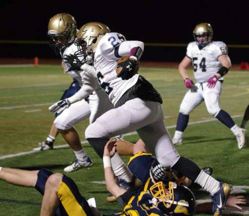 Pope John strong safety Sekayi Rudolph runs with the ball after recovering a Vernon fumble in the second quarter.