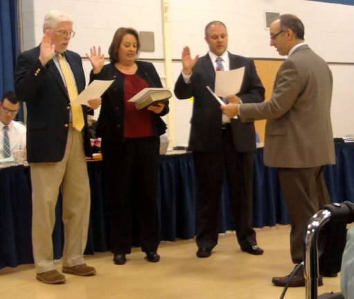 School board members, from left, John McGowan, Lori Lapera and David Sweier are sworn in at a recent worksession.