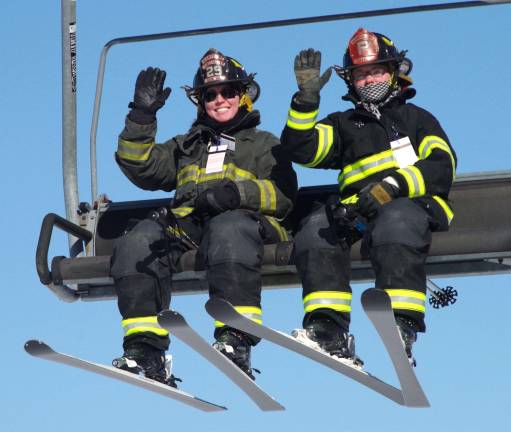 The two ladies of the Vernon Township Fire Department racing team head up the mountain before racing down the slopes at the 28th annual New Jersey Firefighters Ski Race on Friday at Mountain Creek Ski Resort in Vernon.