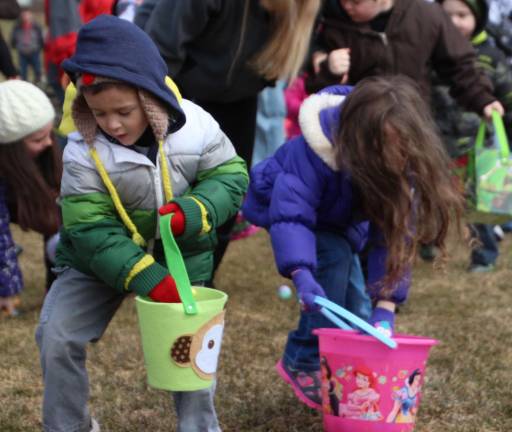 Children gather Easter Eggs during Saturday's egg hunt at Woodbourne Park.