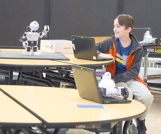 Zach's robot waves to the class.