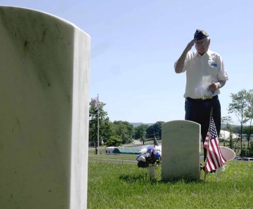 Raymond J. Doyle American Legion Post 86 Salutes and distributes the flag ashes on the grave of a fallen comrade.