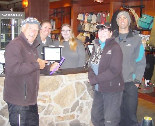 On-snow record holders Buffy and John Whiting pick up their ski passes from Jess, Darlene and Chris Haggerty. .