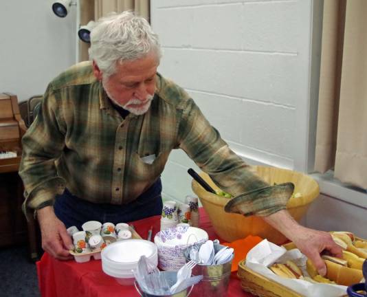 Vernon resident Garry Cucci helps himself to some hotdogs.