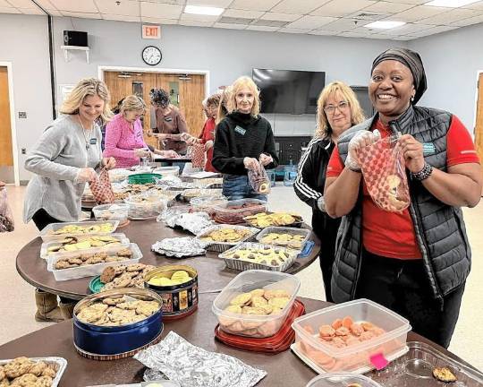 <b>Vernon Township Woman’s Club members Cami Anka, Deb Fegnan and Rosetta Patterson pack homemade cookie at the Feb. 27 meeting. (Photo provided)</b>