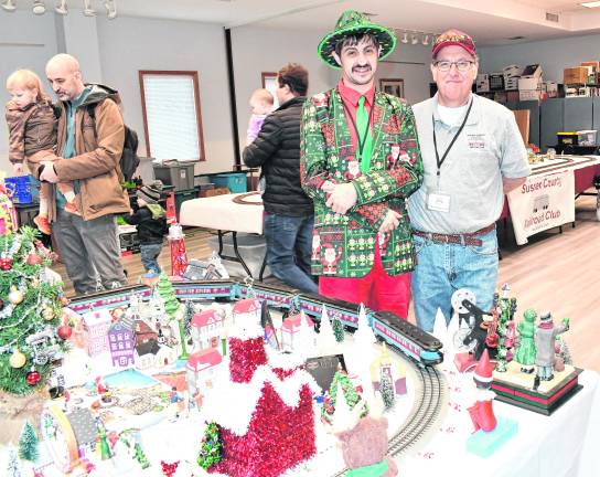 <b>Chad Special, left, and Dean Chamberlain of Stockholm stand behind a train display.</b>