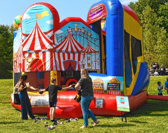 <b>Children’s activities at the street fair included a petting zoo, bounce house, face painting, temporary tattoos and bubbles.</b>