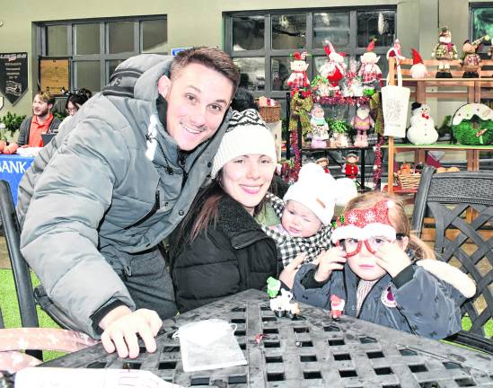 <b>Curtis, Bridget, Lily and Ella Hardenburg of Ledgewood pose at a table.</b>