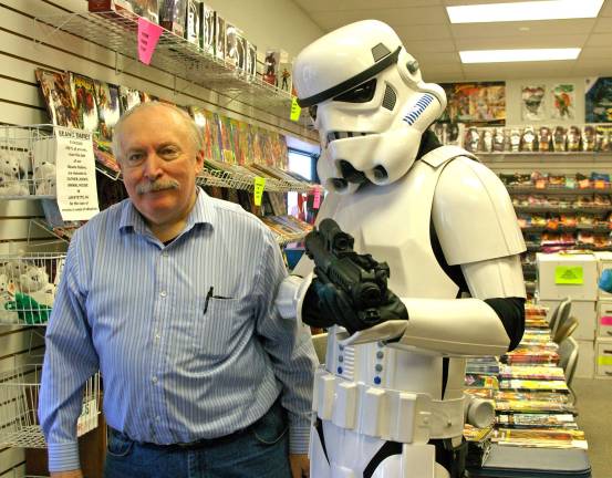 PHOTOS BY CHRIS WYMAN Everybody wanted to pose with the stormtrooper including BobþÄôs Collectables owner Bob Adams on May 1. Stormtrooper TK-41066 was none other than Chris Manning of Vernon, a member of Northeast Remnant, 501st Legion.