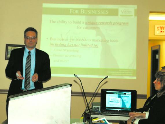 Photo by Mike Zummo George Nikanorov, co-chairman of the Vernon Township Economic Development Advisory Committee gives a presentation on the Shop Vernon program as co-chairwoman Teresa Vihti looks on.