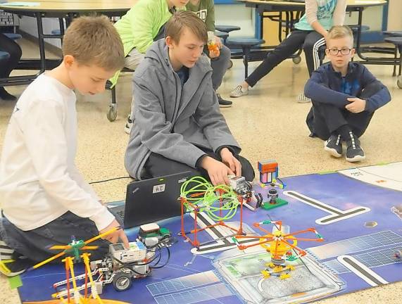 Students demonstrate using robotics and completing missions.