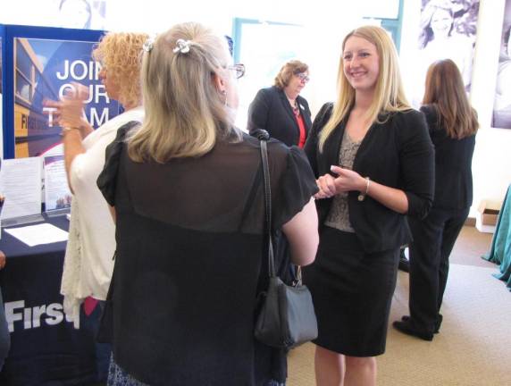 Kyersten Geiger, Project Self-Sufficiency, speaks with a job seeker at a recent Project Self-Sufficiency Career Fair.
