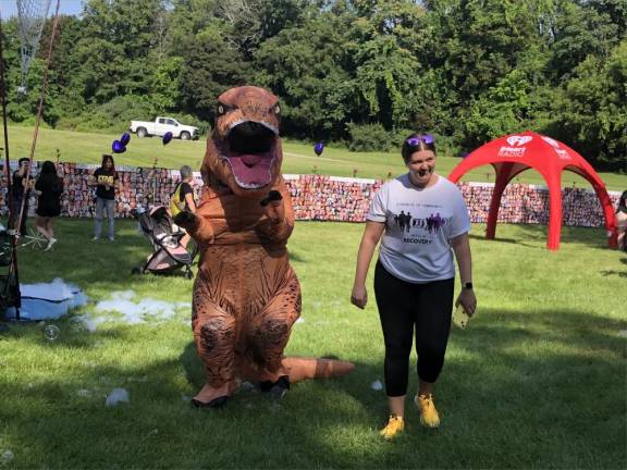 The Center for Prevention &amp; Counseling’s mascot, Rex-4-Recovery T-Rex, greets people at the walk.