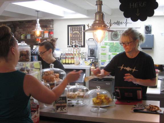 PHOTOS BY JANET REDYKE Krysten Keifer(left) and owner Gina Dobrowolski help patrons on a busy Saturday.