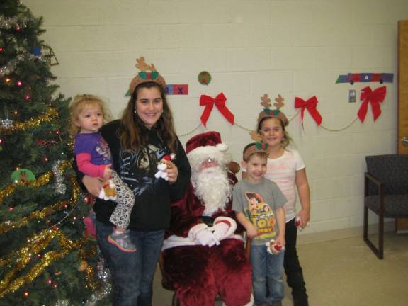 Emma, Alissa, Nico and Kayla pose with Santa.
