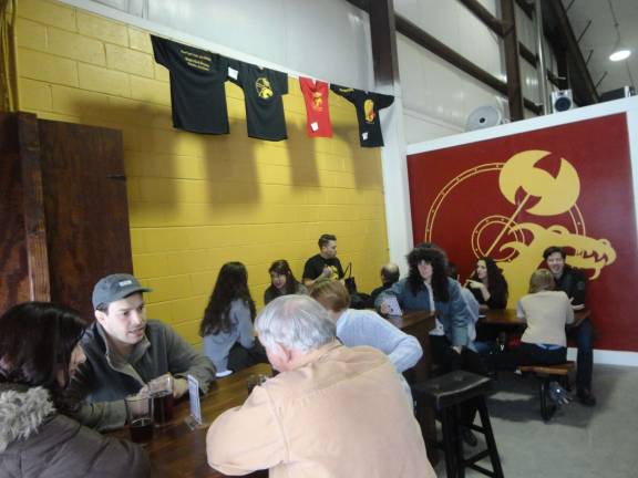 Guests fill the seating area at the Lafayette brewery.