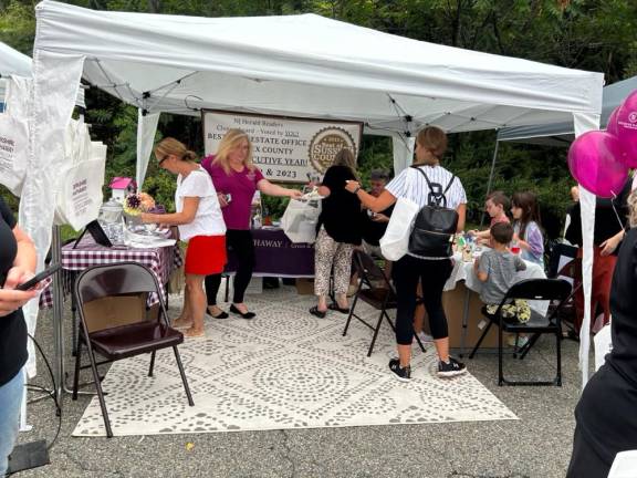 VF3 Children paint wooden birdhouses at a table under the Berkshire Hathaway HomeServices/Gross &amp; Jansen Realtors tent.