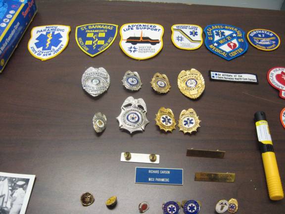 PHOTOS BY JANET REDYKEThe many badges of Vernon Ambulance Squad member Rich Carson honor years of service.