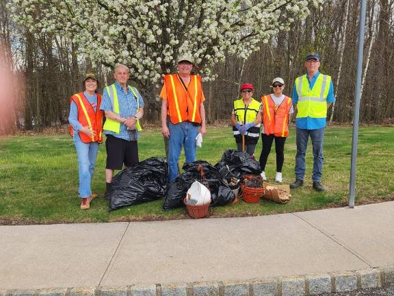 Volunteers, from left, Aileen Donovan, Ken Koenitzer, David Thetge, Lois Wade, Judy Gale and Fred Fogle cleaned up trash at Clove Hill Manor, an adult community in Wantage, on April 15. The reflective vests, gloves, pickers and trash bags were provided by Clean Communities. The money earned from the organization will be donated to the Wantage Ambulance Squad. (Photo provided)