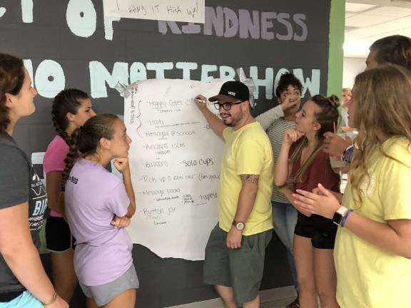 Pass It Along teens work with Mike Misukonis, PIA's director of programs, to plan Youth Leadership Conference, the annual gathering of high school students run by Pass It Along Photos provided by PIA