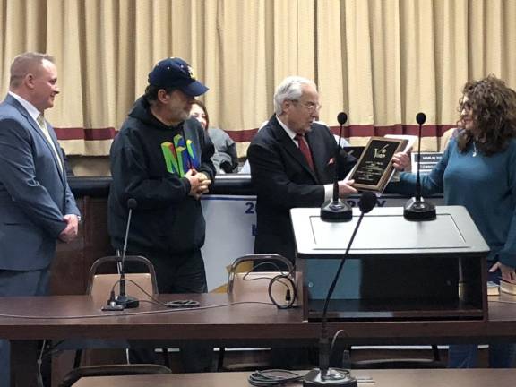 Councilman Phil Rizzuto presents a plaque to former Councilman Joe Tadrick, second from left. At left is Mayor Anthony Rossi. At right is Councilwoman Natalie Buccieri.