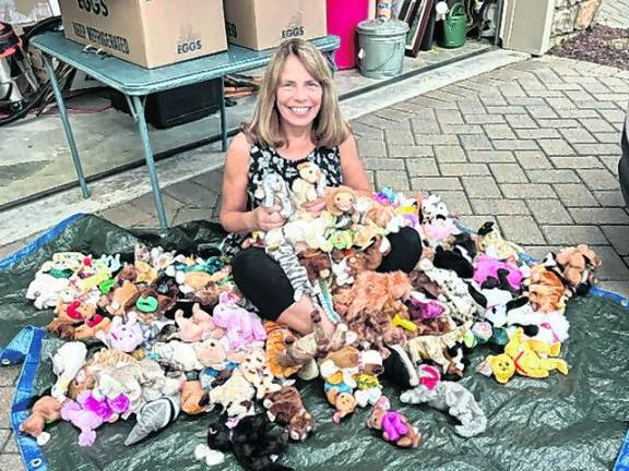 <b>Vernon Township Woman’s Club member Lisa Mills sits among the collection of cuddly Beanie Babies the club recently donated to Operation Smile for children undergoing cleft palate surgery.</b>