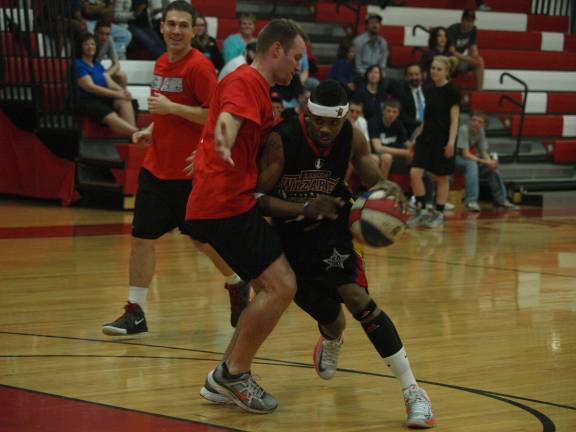 The Wizards Derek "Downtown" Braxton drives past his opponent.