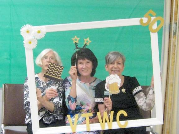 Woman’s Club members Joan Danaher, Judy Phillips and Arleen Hill frame themselves at the party.